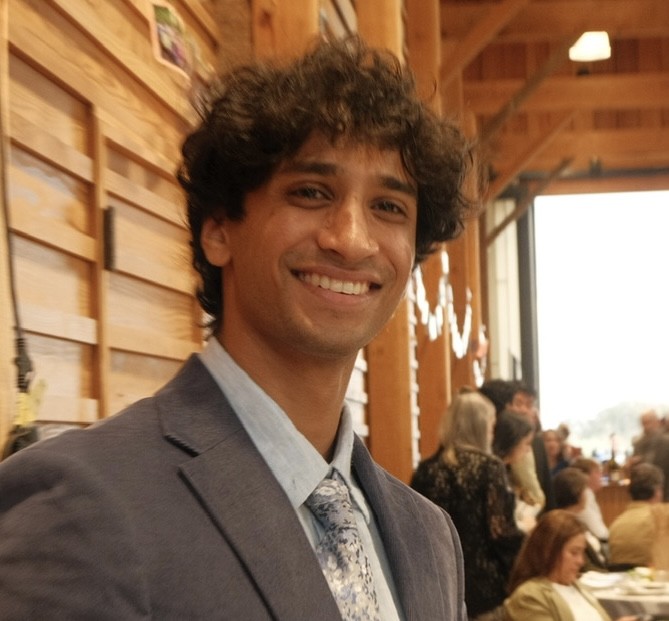 Nikhil Marudai smiling at an indoor gathering